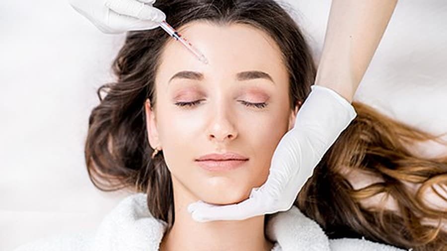 Botox treatment in Bethesda, MD — a patient receiving a cosmetic injection to the forehead